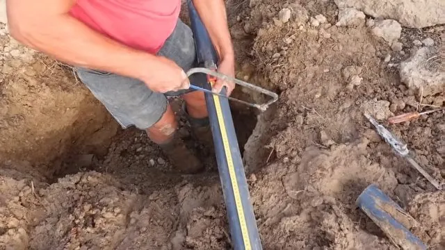 Repaired sewer line aligned inside an open trench