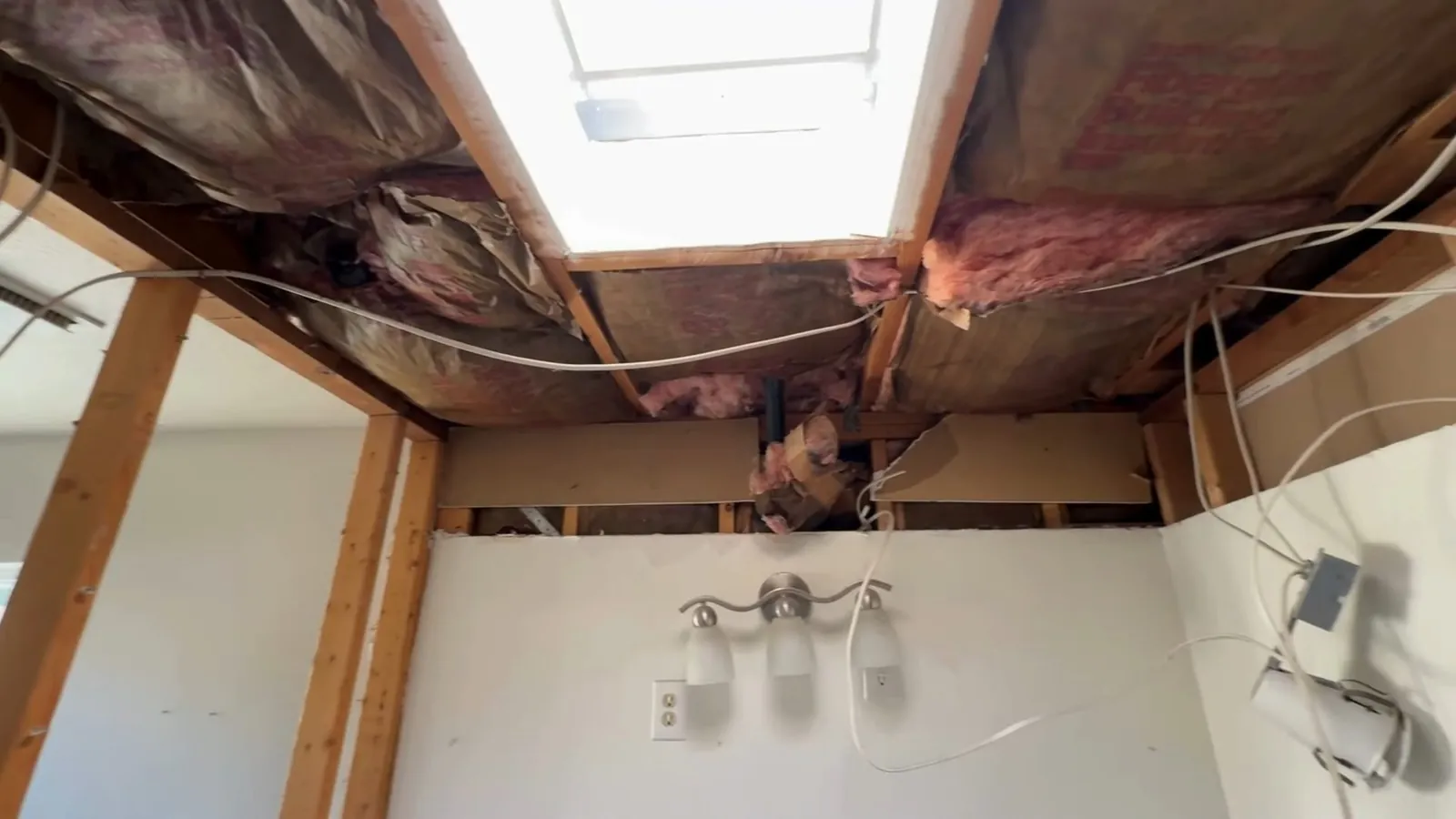 Bathroom ceiling with exposed joists during a remodel