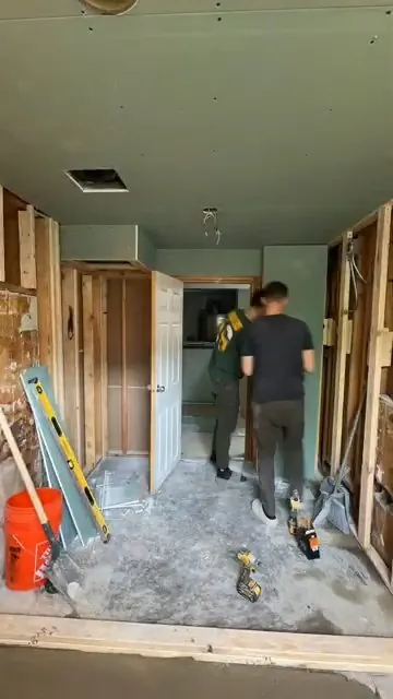 Bathroom renovation with open wall studs exposing plumbing