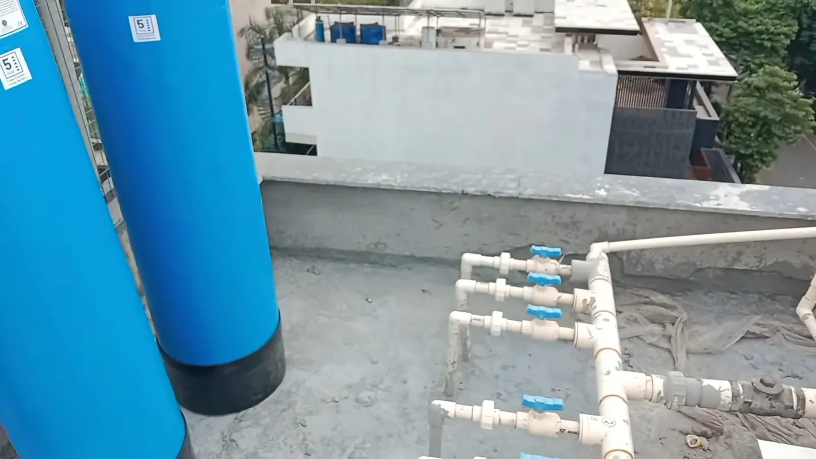 Blue water softener system installed against a utility wall
