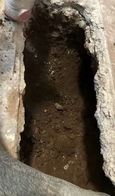 Concrete slab trench opened beside a water pipe