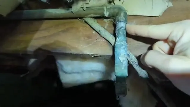 Old galvanized pipe replaced with new PEX piping in a crawlspace