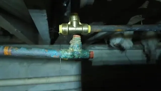 Frozen copper pipe cut out near a foundation wall