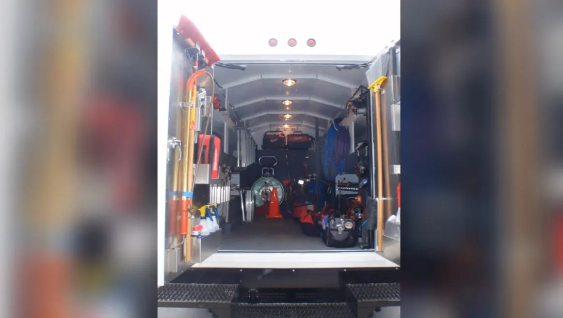 Dispatcher taking a call from inside a plumbing service van