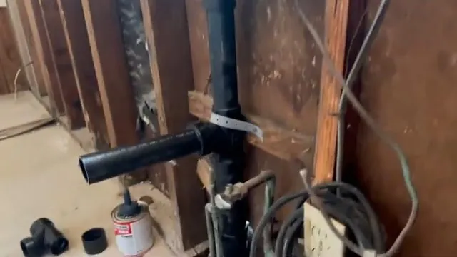 Trenchless sewer pipe exposed beneath a floor