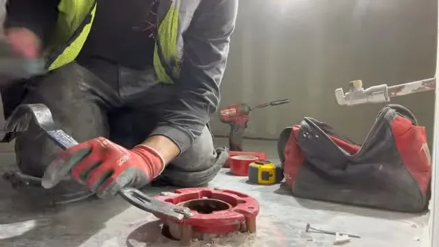 Commercial toilet flange ground down at the floor