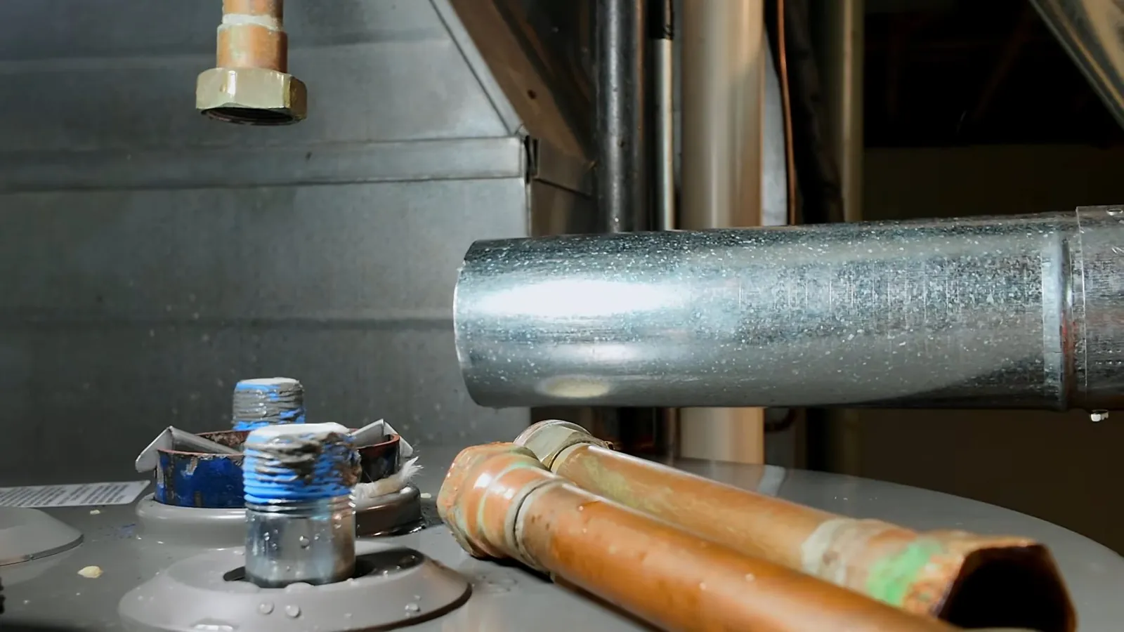 Hot water supply pipes routed over a water heater