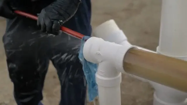 Grease buildup being stripped from a pipe wall during hydro jetting