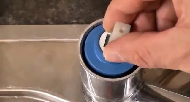 Cartridge cap lifted from a kitchen faucet during repair