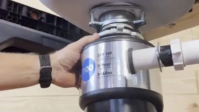 New garbage disposal unit mounted under a kitchen sink