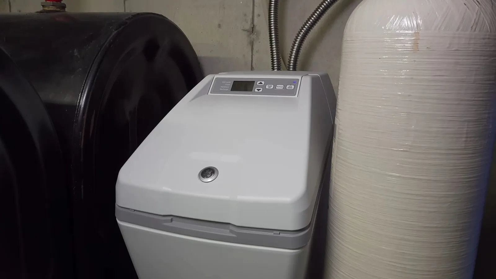 Water softener system with an open brine tank in a utility room