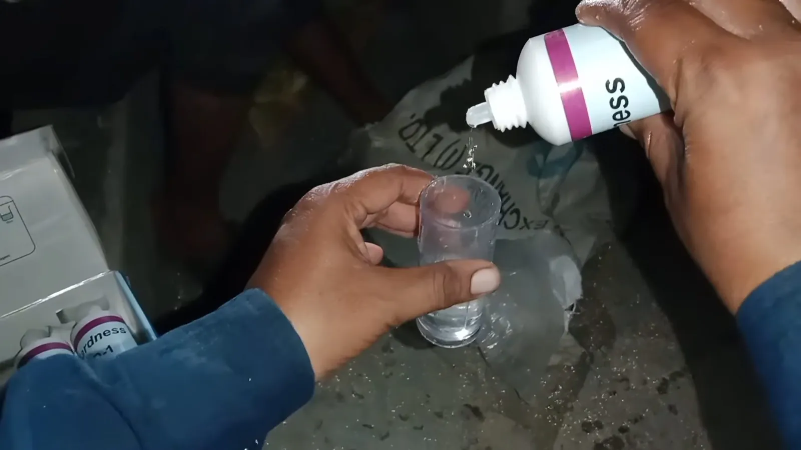 Plumber installing a blue water softener control valve