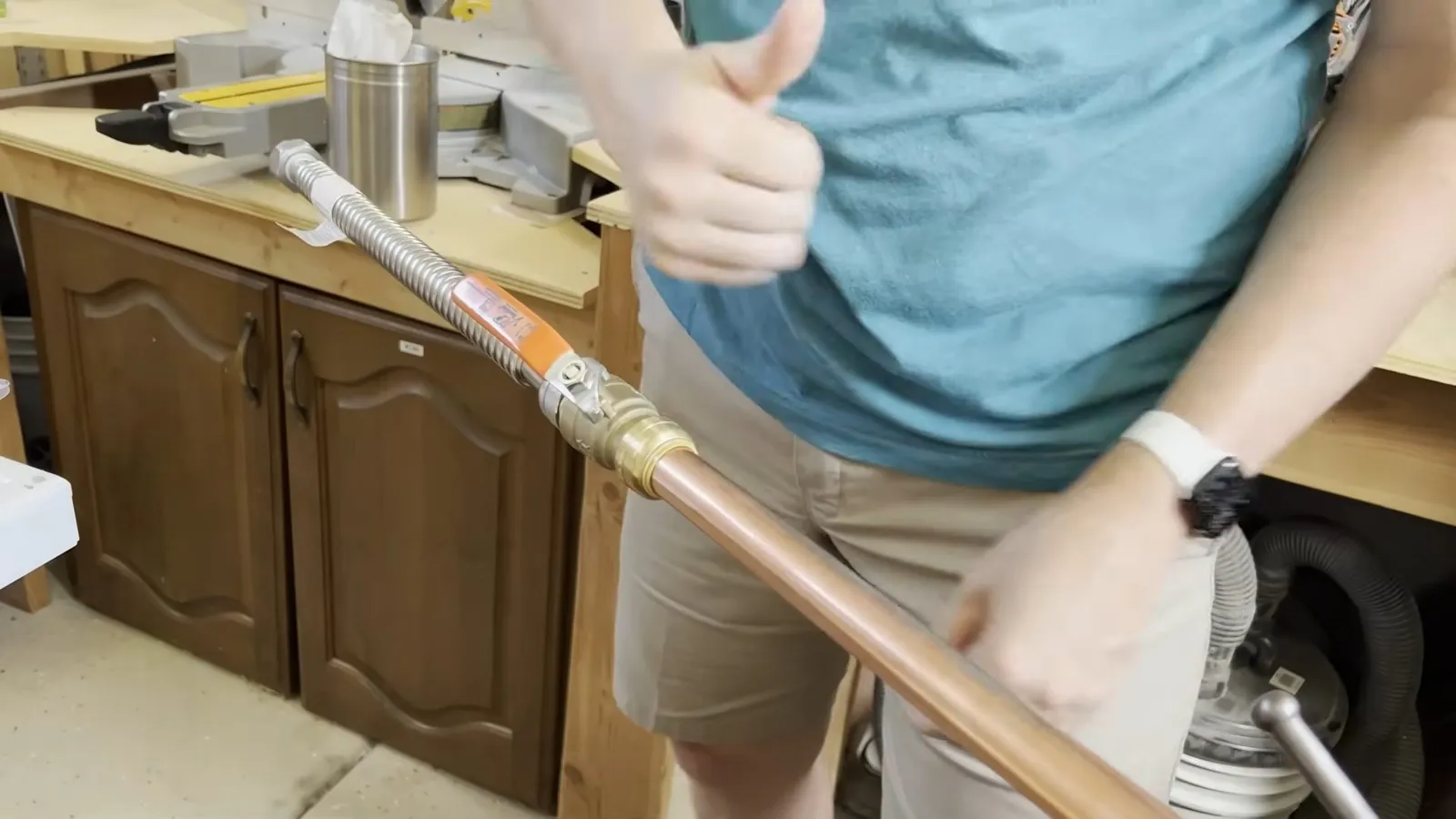 Plumber installing supply pipe for a new tank water heater