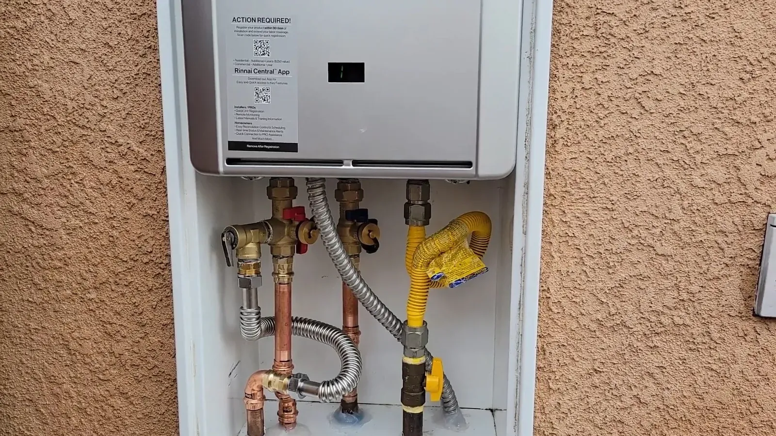 Small point-of-use tankless water heater mounted under a bathroom sink