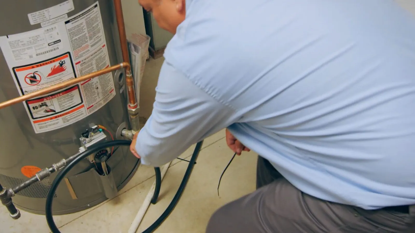 Technician fitting a bypass valve on a water softener