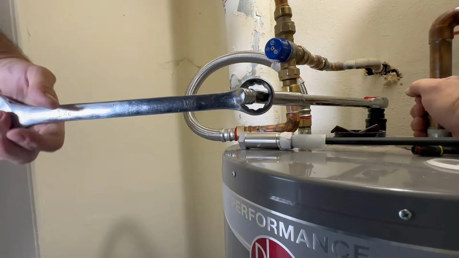Water heater anode rod being loosened for replacement
