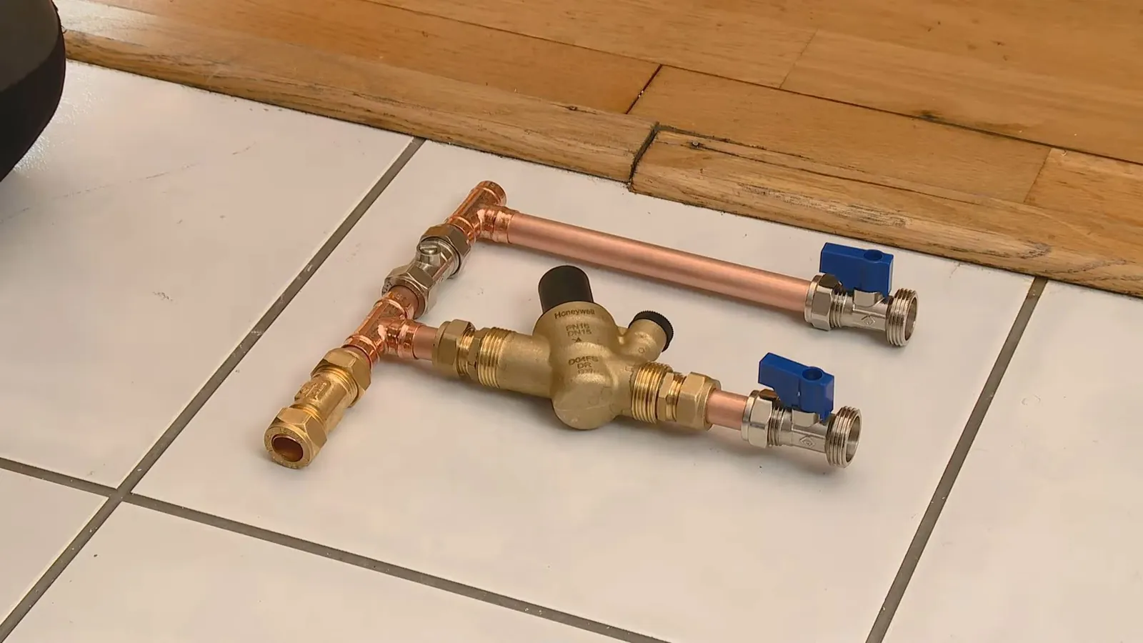Water softener installation fittings laid out on a table