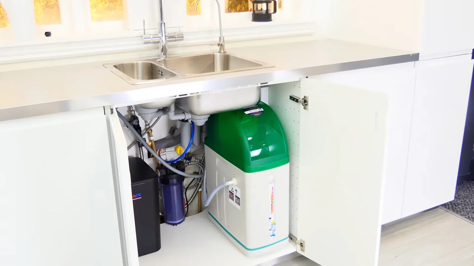 Whole-home water filtration system installed alongside a water softener